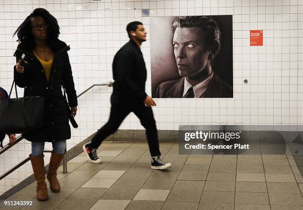 Pictures of rock legend Davis Bowie line the walls of a New York City subway station on April 25, 2018 in New York City. Besides concert photos and...