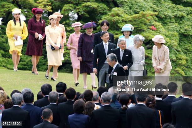 Emperor Akihito, Empress Michiko and royal family members walk toward guests during the spring garden party at the Akasaka Imperial Garden on April...