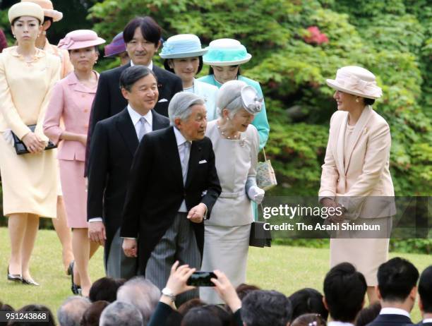 Emperor Akihito, Empress Michiko and royal family members walk toward guests during the spring garden party at the Akasaka Imperial Garden on April...