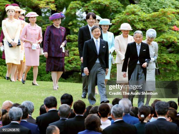 Emperor Akihito, Empress Michiko and royal family members walk toward guests during the spring garden party at the Akasaka Imperial Garden on April...