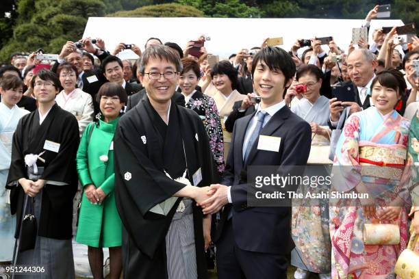 Olympic gold medalist Yuzuru Hanyu and professional Shogi player Yoshiharu Habu shake hands during the spring garden party at the Akasaka Imperial...