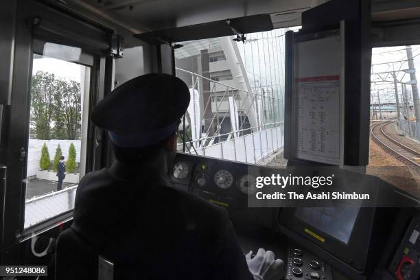 Train runs past the crash site on April 25, 2018 in Amagasaki, Hyogo, Japan. The worst train accident in 40 years killed 107 people and injured 562,...