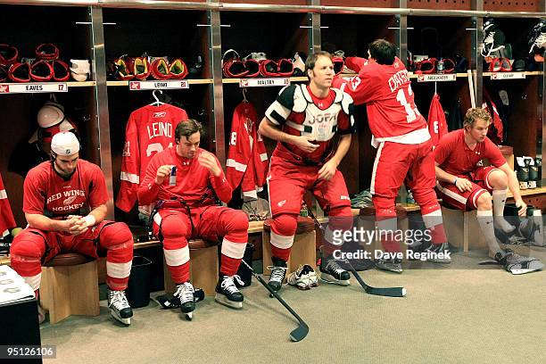 Patrick Eaves of the Detroit Red Wings, Ville Leino, Kirk Maltby, Pavel Datsyuk and Justin Abdelkader get ready for warm-ups in the locker room prior...