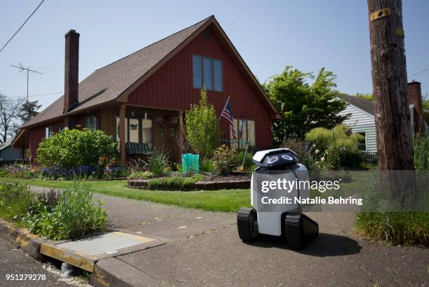 Delivery robot 'DAX' is seen looking both ways at an intersection on April 25, 2018 in Philomath, Oregon. Joseph Sullivan, the inventor of DAX is a...