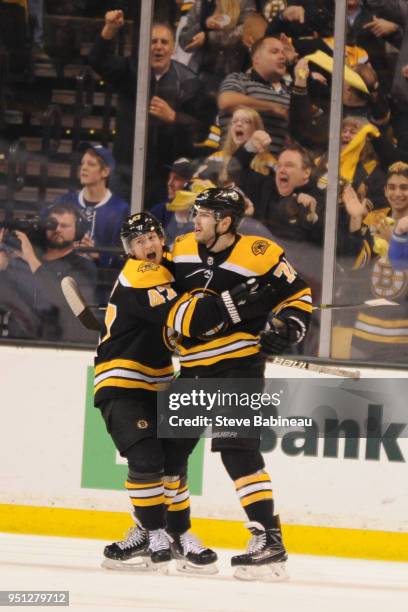 Torey Krug and Jake DeBrusk of the Boston Bruins celebrate the goal against the Toronto Maple Leafs in Game Seven of the Eastern Conference First...