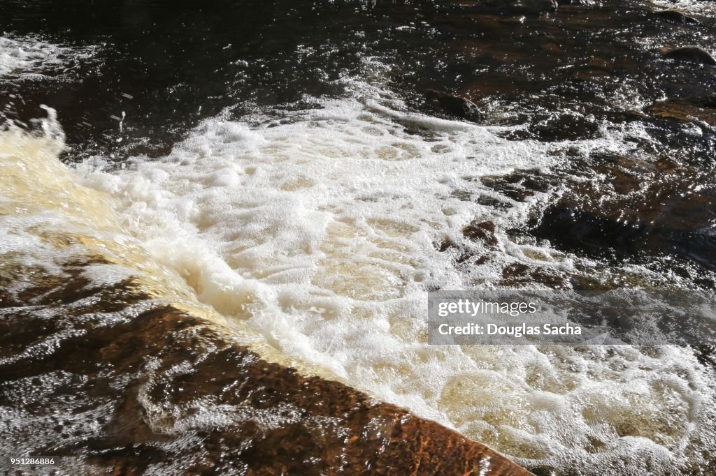 Looking down at a waterfall on a fast moving river