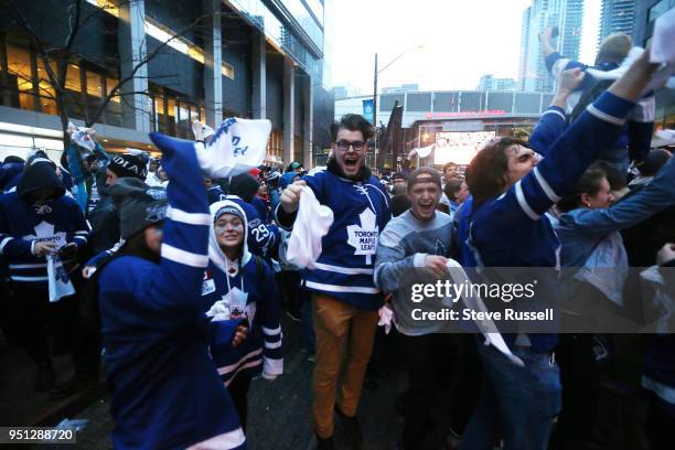 Toronto Maple Leafs fans outside cheer as the Leafs score. Fans are watching the game on Bremner as all Toronto professional sports franchises are...