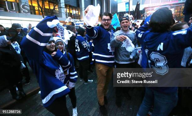 Toronto Maple Leafs fans outside cheer as the Leafs score. Fans are watching the game on Bremner as all Toronto professional sports franchises are...