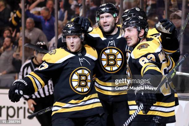 Torey Krug of the Boston Bruins, David Backes and Brad Marchand celebrate with Patrice Bergeron after he scored a goal against the Toronto Maple...