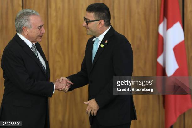 Michel Temer, Brazil's president, left, shakes hands with Andrea Semadeni, Switzerland's ambassador to Brazil, during a ceremony of accreditation at...