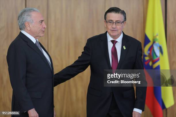 Michel Temer, Brazil's president, left, speaks with Diego Antonio Rivadeneira Espinosa, Ecuador's ambassador to Brazil, during a ceremony of...