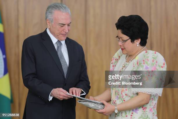 Michel Temer, Brazil's president, left, speaks with Marichu Mauro, Philippines's ambassador to Brazil, during a ceremony of accreditation at the...