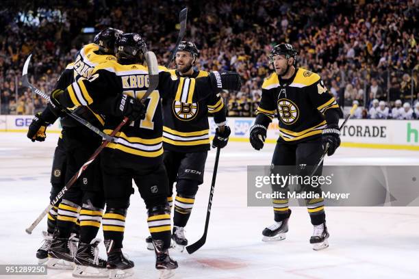 Jake DeBrusk of the Boston Bruins celebrates with Torey Krug, David Backes and David Krejci after scoring a goal against the Toronto Maple Leafs...