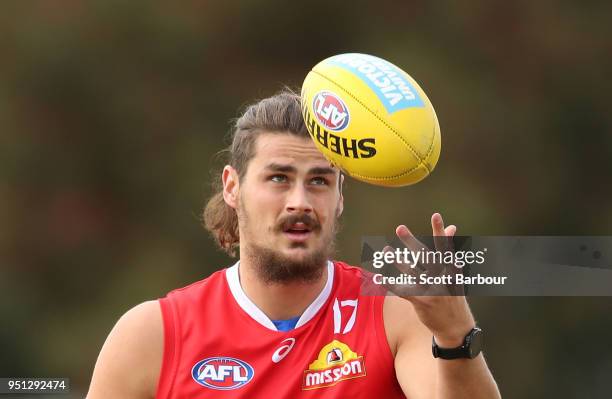 Tom Boyd of the Bulldogs holds the ball during a Western Bulldogs AFL training session at Whitten Oval on April 26, 2018 in Melbourne, Australia.