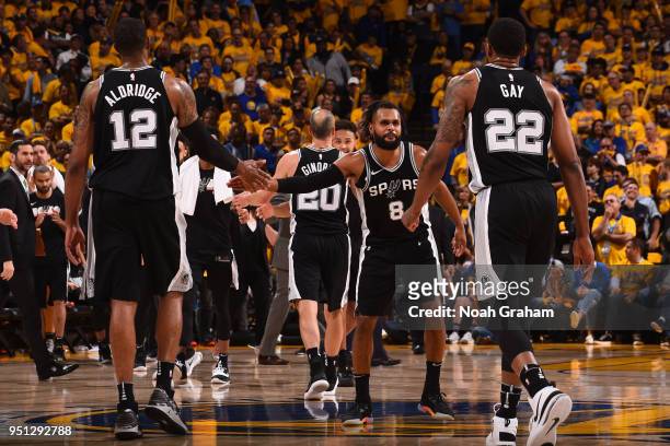 LaMarcus Aldridge of the San Antonio Spurs and Patty Mills of the San Antonio Spurs exchange a high give against the Golden State Warriors in Game...