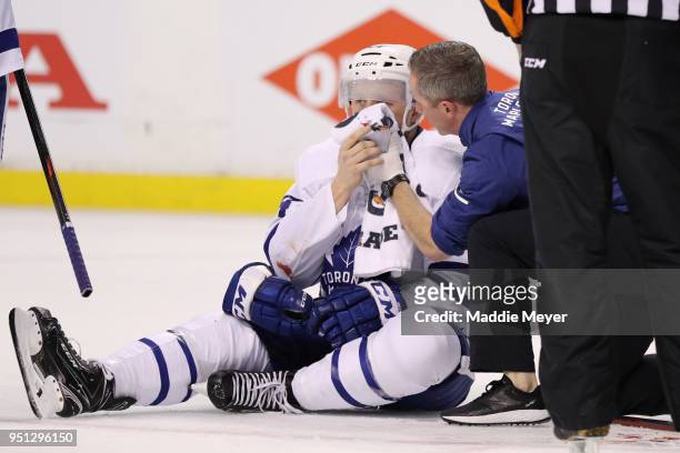 Morgan Rielly of the Toronto Maple Leafs is tended to during the first period against the Boston Bruins in Game Seven of the Eastern Conference First...