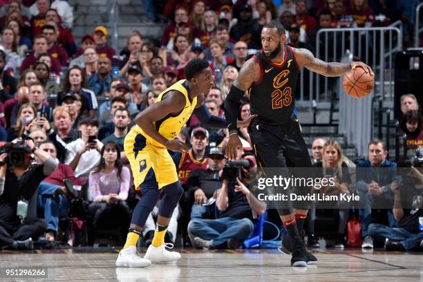 LeBron James of the Cleveland Cavaliers handles the ball against Victor Oladipo of the Indiana Pacers in Game Five of Round One of the 2018 NBA...