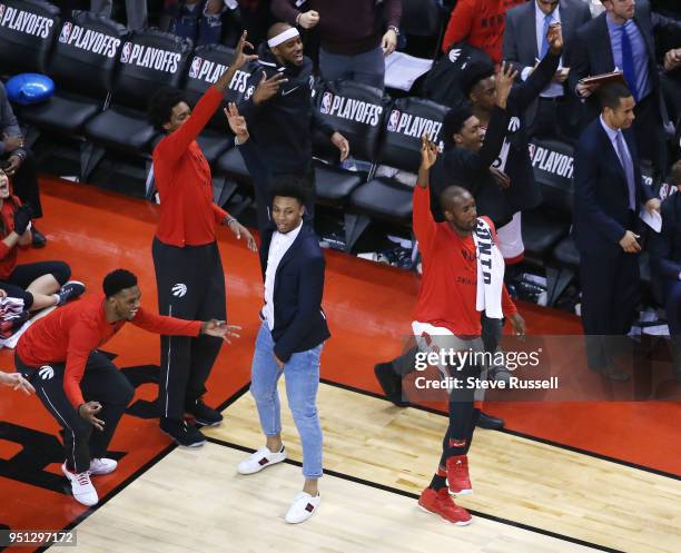 The Toronto bench celebrates a CJ Miles three pointer as the Toronto Raptors win game five of their first round of the NBA playoffs against the...