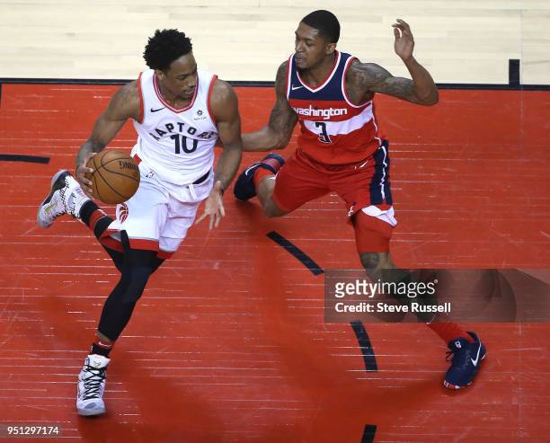 Toronto Raptors guard DeMar DeRozan drives against Washington Wizards guard Bradley Beal as the Toronto Raptors win game five of their first round of...