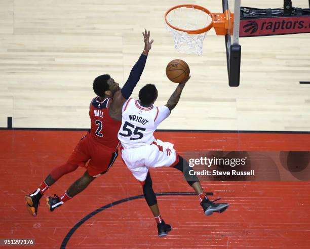 Toronto Raptors guard Delon Wright puts up a shot against Washington Wizards guard John Wall as the Toronto Raptors win game five of their first...