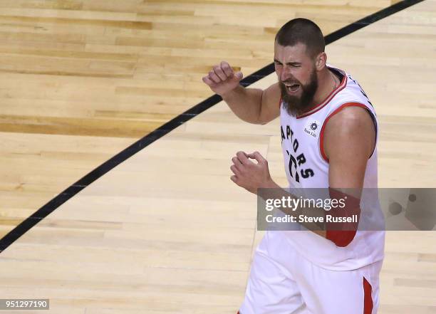 Toronto Raptors center Jonas Valanciunas celebrates after tipping in a ball as the Toronto Raptors win game five of their first round of the NBA...