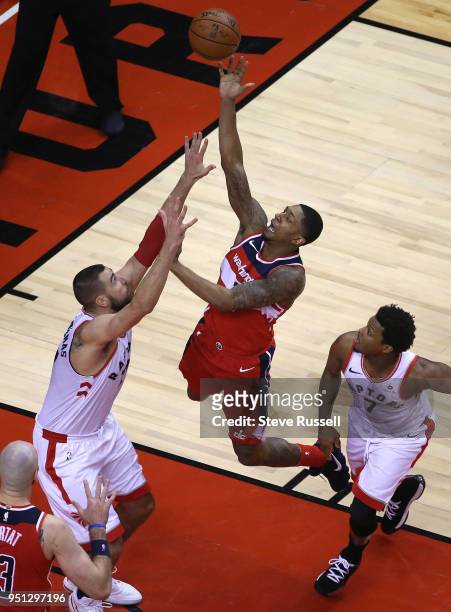 Washington Wizards guard Bradley Beal tries to get the ball over Toronto Raptors center Jonas Valanciunas as the Toronto Raptors win game five of...