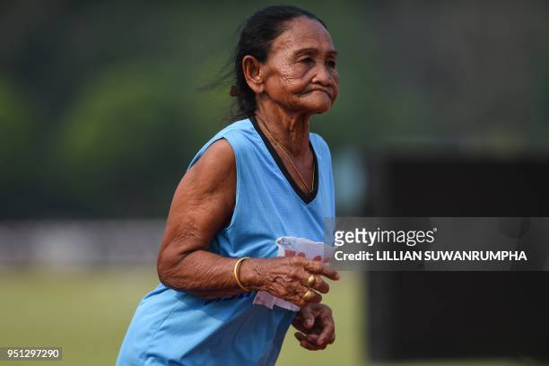 This photo taken on April 25, 2018 shows an elderly woman in the 65-70 age category competing in the 400-metre race during Thailand's first national...