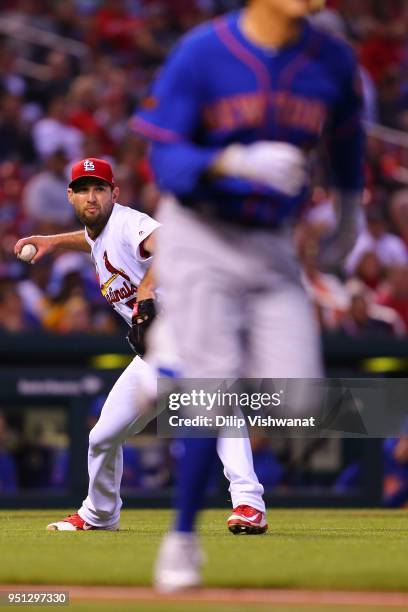 Michael Wacha of the St. Louis Cardinals throws a run out at first base against the New York Mets in the second inning at Busch Stadium on April 25,...