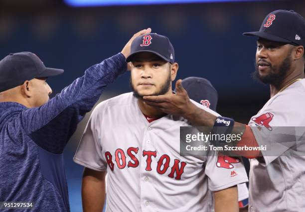 Eduardo Rodriguez of the Boston Red Sox exits as he is relieved by manager Alex Cora as Hanley Ramirez lifts his chin up in the seventh inning during...