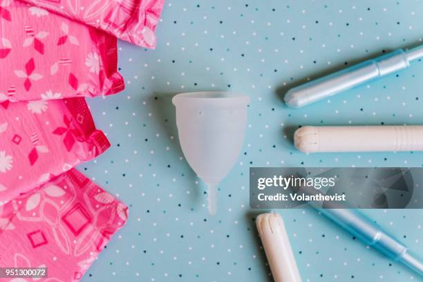 menstrual cup on blue background - tampon stock pictures, royalty-free photos & images