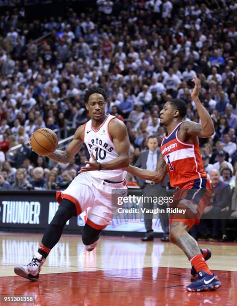 DeMar DeRozan of the Toronto Raptors drives the lane against Bradley Beal of the Washington Wizards defends during the second half of Game Five in...