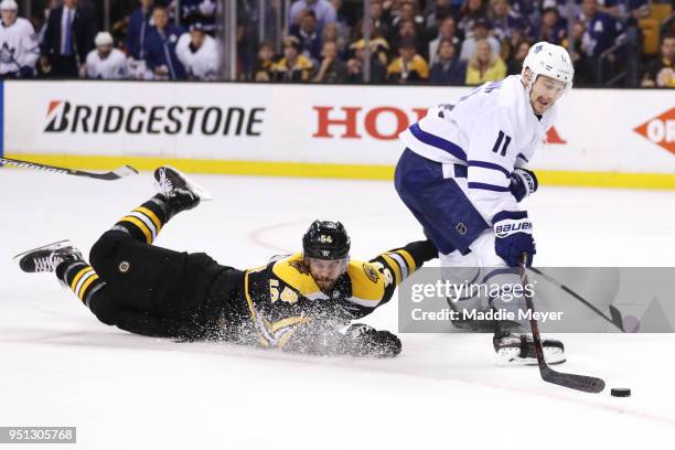 Adam McQuaid of the Boston Bruins dives to defend Zach Hyman of the Toronto Maple Leafs during the second period of Game Seven of the Eastern...