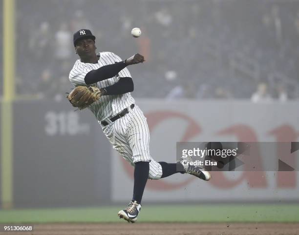 Didi Gregorius of the New York Yankees makes the last out of the game as he fields a hit by Eduardo Escobar of the Minnesota Twins in the ninth...