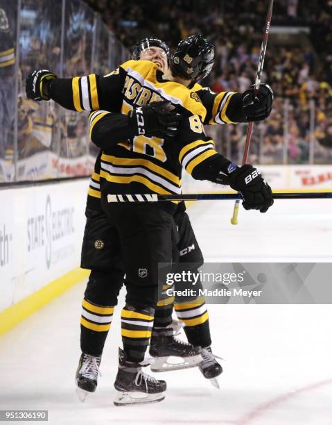 David Pastrnak of the Boston Bruins celebrates with Charlie McAvoy after scoring a goal against the Toronto Maple Leafs during the third period of...