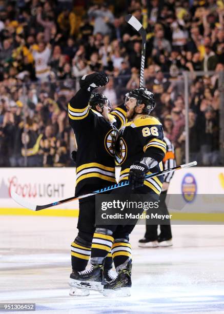 Torey Krug of the Boston Bruins celebrates with Kevan Miller after scoring a goal against the Toronto Maple Leafs during the third period of Game...