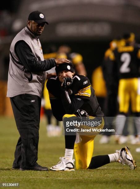 Head coach Mike Tomlin talks with Ben Roethlisberger of the Pittsburgh Steelers while waiting for the game winning touchdown call to be confirmed by...