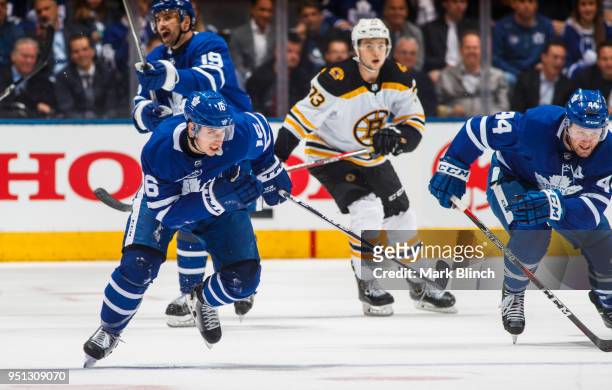 Mitchell Marner of the Toronto Maple Leafs skates with teammate Morgan Rielly against the Boston Bruins in Game Six of the Eastern Conference First...