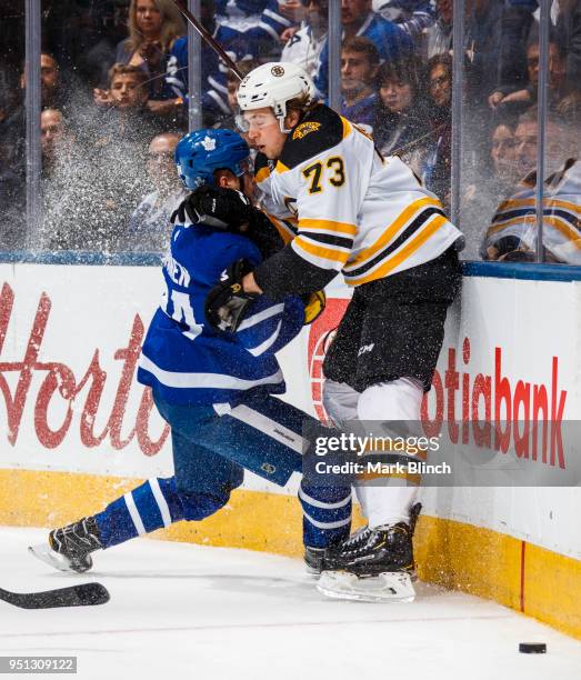 Kasperi Kapanen of the Toronto Maple Leafs checks Charlie McAvoy of the Boston Bruins in Game Six of the Eastern Conference First Round during the...