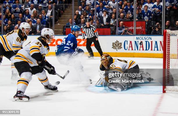 Kasperi Kapanen of the Toronto Maple Leafs goes to the net against Tuukka Rask, Torey Krug, and David Pastrnak of the Boston Bruins in Game Six of...