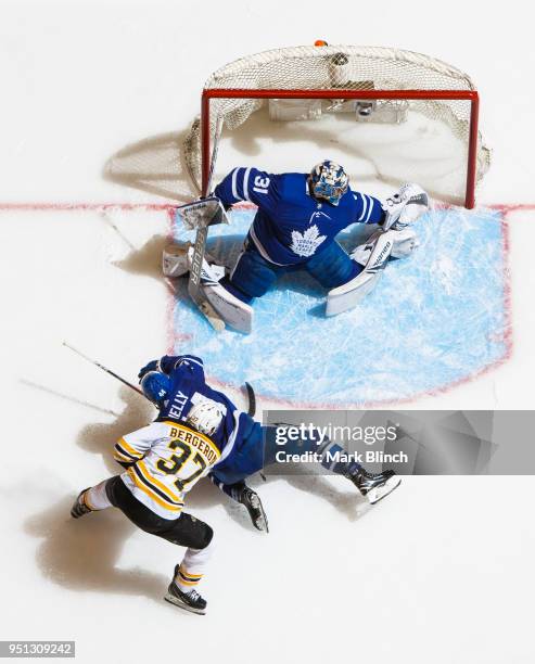 Patrice Bergeron of the Boston Bruins goes to the net against Morgan Rielly and Frederik Andersen of the Toronto Maple Leafs in Game Six of the...