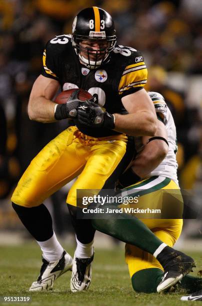 Heath Miller of the Pittsburgh Steelers attempts to break through a tackle by AJ Hawk of the Green Bay Packers during the game on December 20, 2009...