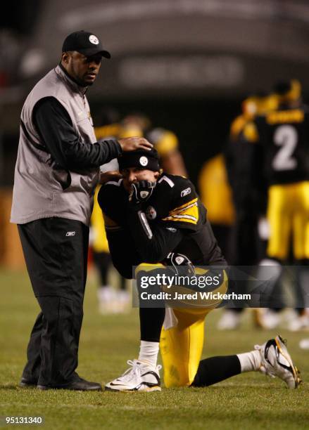 Head coach Mike Tomlin talks with Ben Roethlisberger of the Pittsburgh Steelers while waiting for the game winning touchdown call to be confirmed by...