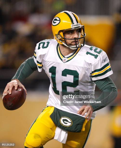 Aaron Rodgers of the Green Bay Packers scrambles away from the defense of the Pittsburgh Steelers during the game on December 20, 2009 at Heinz Field...