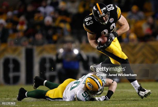 Heath Miller of the Pittsburgh Steelers attempts to break through a tackle by AJ Hawk of the Green Bay Packers during the game on December 20, 2009...