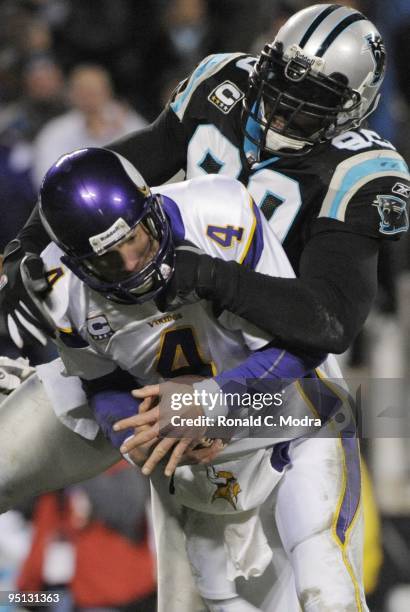 Quarterback Brett Favre of the Minnesota Vikings is sacked by Julius Peppers of the Carolina Panthers during a NFL game at Bank of America Stadium on...