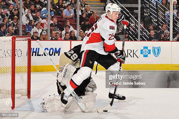 Chris Neil of the Ottawa Senators attempts to redirect a shot past goaltender Marc-Andre Fleury of the Pittsburgh Penguins on December 23, 2009 at...