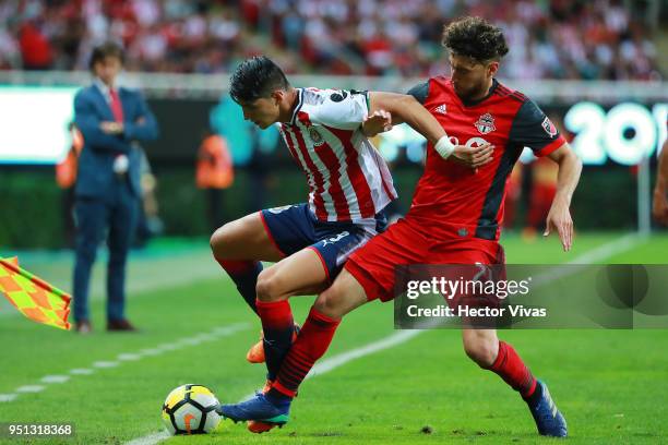 Alan Pulido of Chivas struggles for the ball with Jonathan Osorio of Toronto FC during the second leg match of the final between Chivas and Toronto...