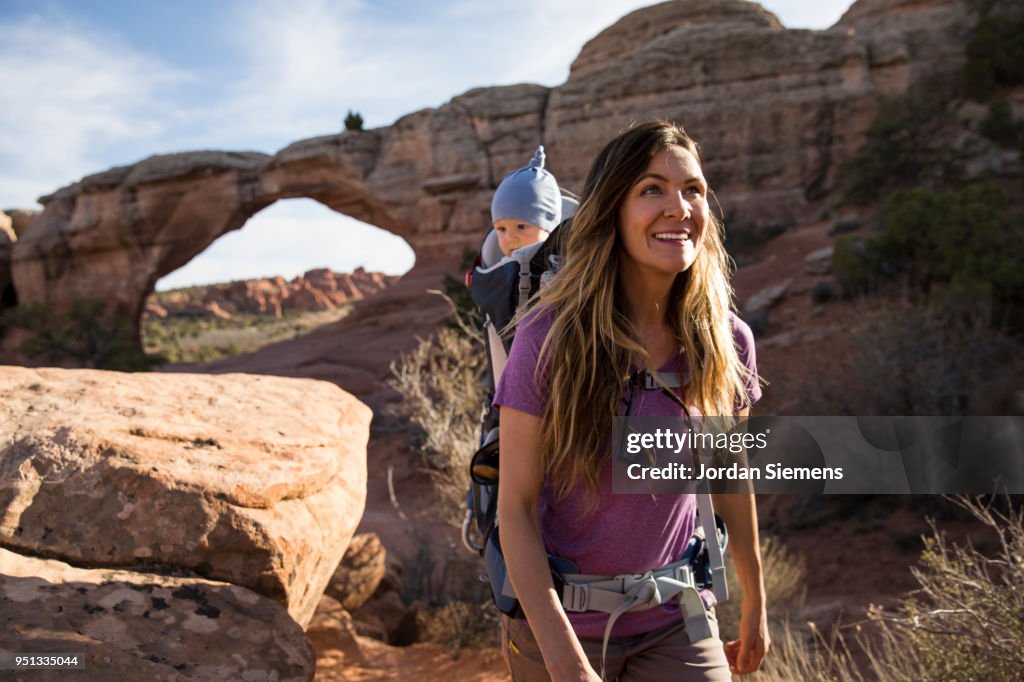 A young mom hiking with her baby