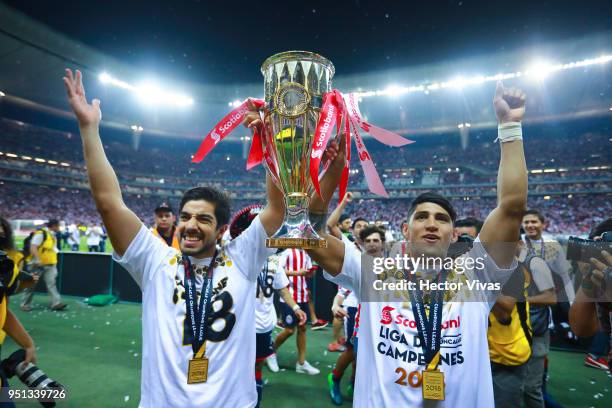 Isaac Brizuela and Alan Pulido of Chivas celebrate with the champion trophy during the second leg match of the final between Chivas and Toronto FC as...