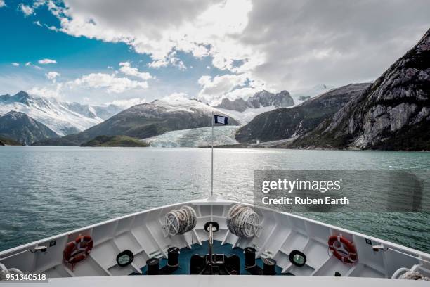 ship's bow with the pia glacier in the distance - fjord stock pictures, royalty-free photos & images